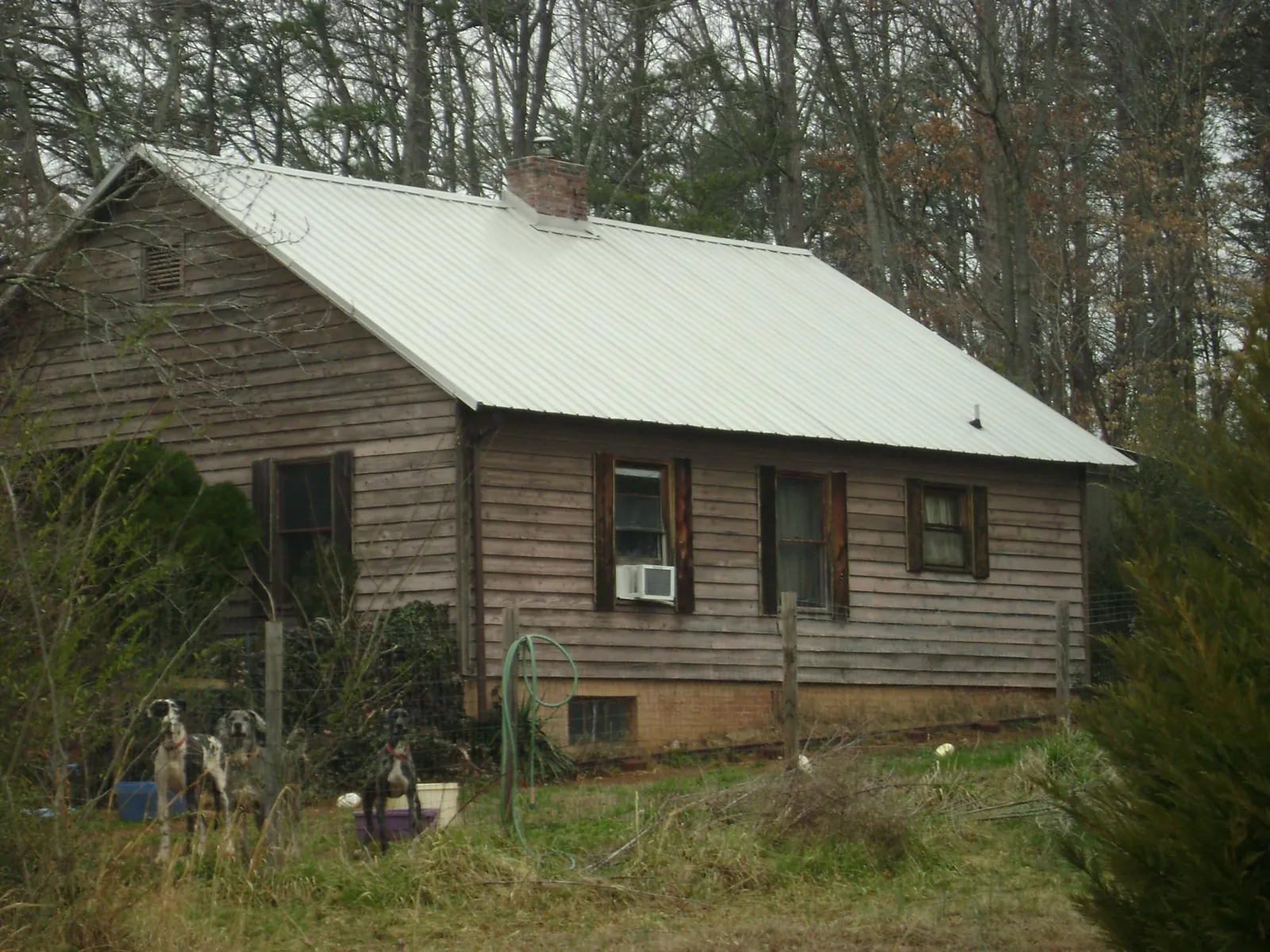 White metal roof on an old wood sided farmhouse, from a Metal Roof Installation job in Rowena